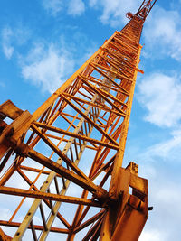 Low angle view of crane against sky