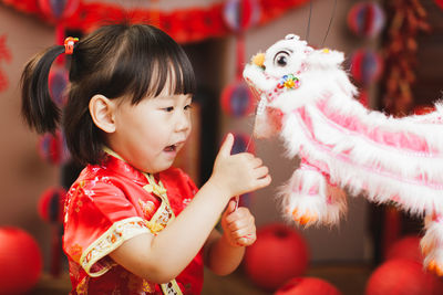 Portrait of cute girl with toys