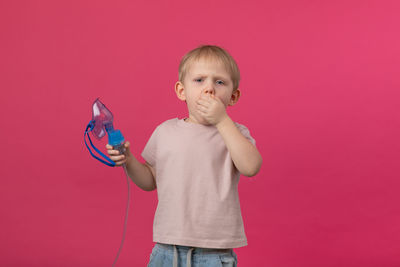 Portrait of boy holding bubbles