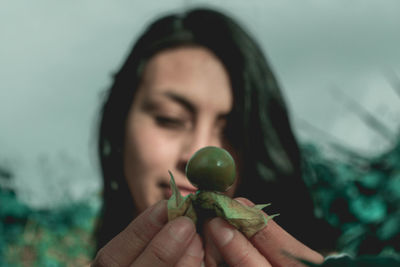 Close-up of woman holding fruit