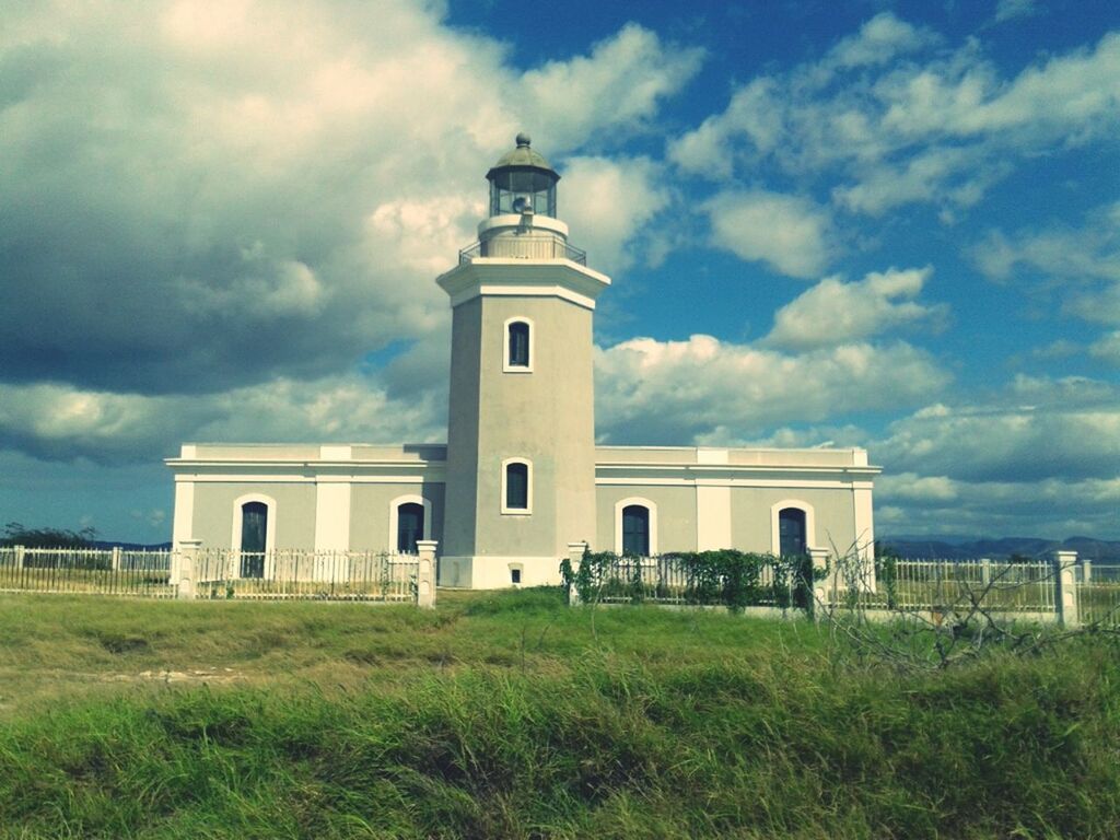 architecture, built structure, building exterior, sky, grass, cloud - sky, cloud, cloudy, field, lighthouse, day, low angle view, grassy, outdoors, green color, arch, protection, lawn, nature, tower