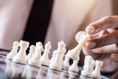 Midsection of man playing chess