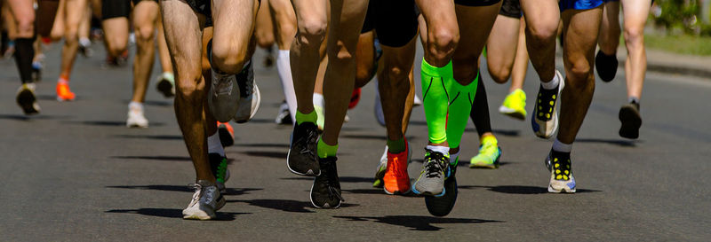 Low section of people walking on street