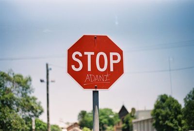 Low angle view of road sign against sky