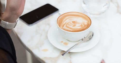 High angle view of coffee cup on table