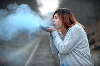 Woman blowing powder paint