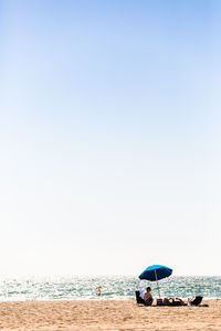 Boat on beach against clear sky