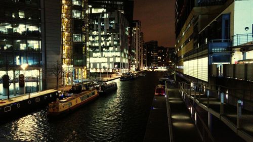 Boats in canal along buildings