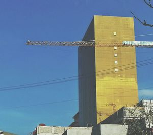 Low angle view of building against clear blue sky