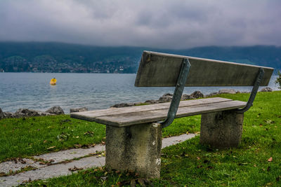 Empty bench at lakeshore