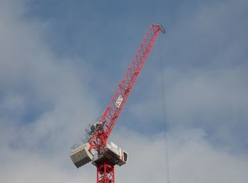 Low angle view of crane against sky