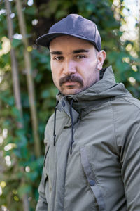 Close-up portrait of a moroccan man wearing a black unbranded hat and a green jacket