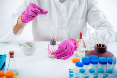 Perfumer holding a stick with aromatic oil.