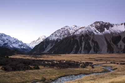 Scenic view of snowcapped mountains against clear sky