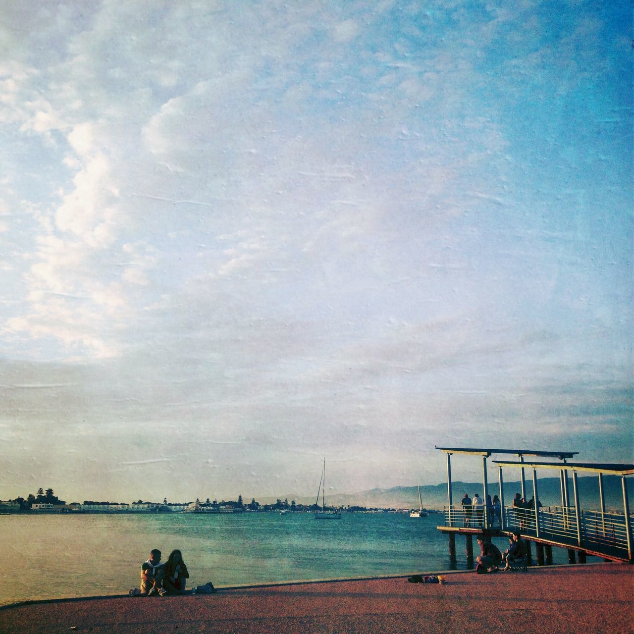 sea, water, sky, horizon over water, beach, cloud - sky, railing, men, tranquility, scenics, leisure activity, lifestyles, tranquil scene, nature, shore, beauty in nature, pier, person, silhouette