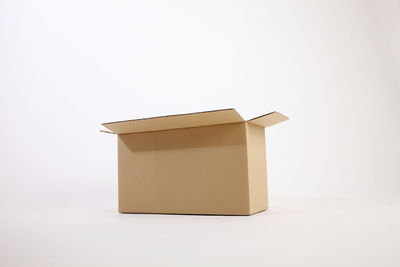Close-up of cardboard box over white background