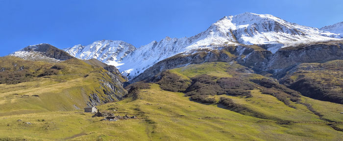 Beautiful european alpine mountain wtih snowy peak background under blue sky