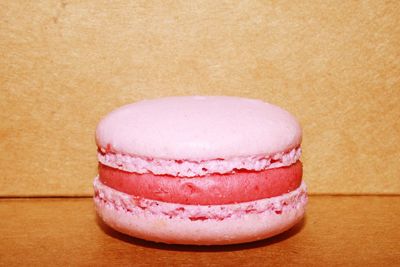 Close-up of pink macaroon on table