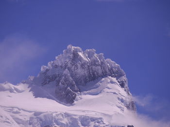 Low angle view of snowcapped mountain against blue sky. torres del paine mountains, chile