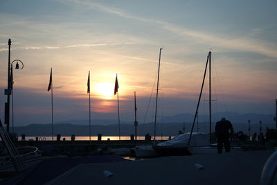 Silhouette sailboats against sky during sunset