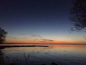 Scenic view of sea against sky at dusk