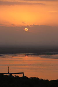 Scenic view of sea against romantic sky at sunset