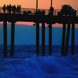 Pier on sea at sunset