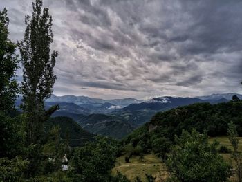 Scenic view of mountains against cloudy sky