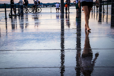 Low section of people on wet puddle