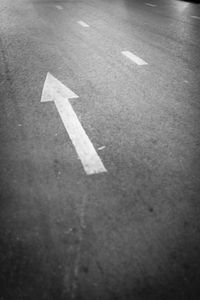 High angle view of arrow sign on road