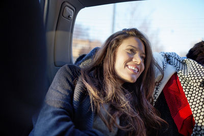 Woman looking away while traveling in car