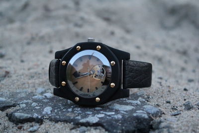 Close-up of wristwatch on rock