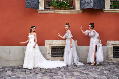 Rear view of couple standing against wall