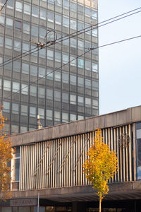 Low angle view of glass building against sky