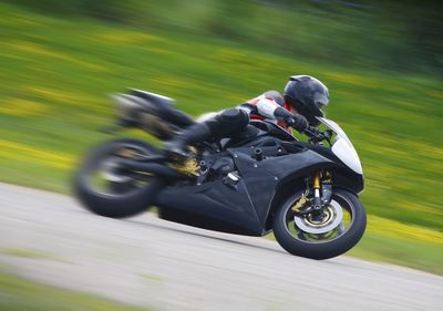 Blurred motion of man riding motorcycle