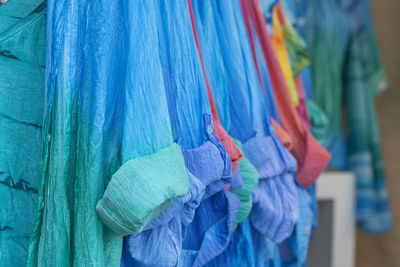 Close-up of multi colored clothing hanging at market stall