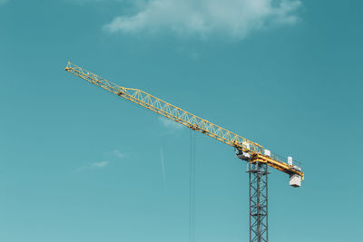 Low angle view of crane against sky