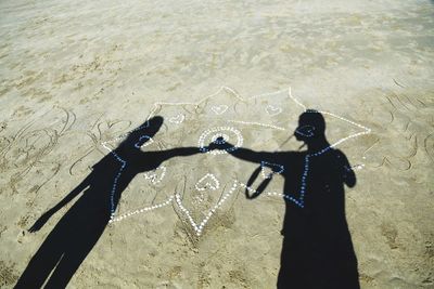 High angle view of couple standing on beach