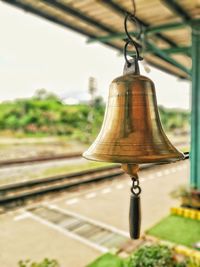 Close-up of bell hanging on railroad station