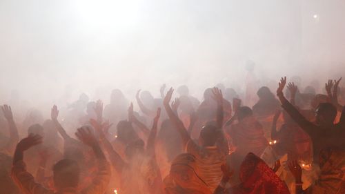 People are praying at rakher upobash in a smokey environment