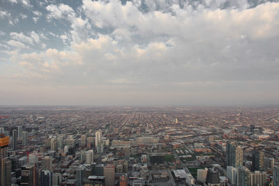 High angle view of illuminated city buildings against sky