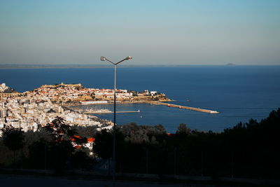 Scenic view of sea of kavala greece by buildings against sky