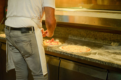 Midsection of man preparing food