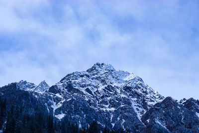 Low angle view of snowcapped mountain against sky