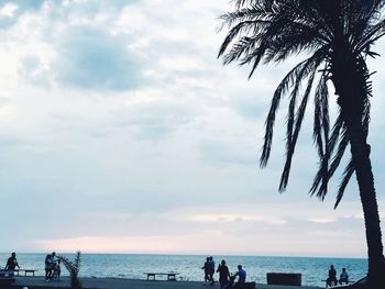 People on beach against sky