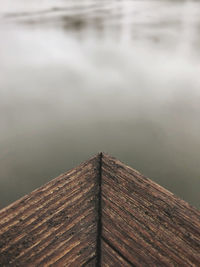 Close-up of wooden pier with a misty river 