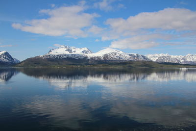 Scenic view of lake and mountains against sky during winter