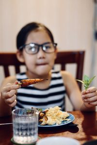 Portrait of boy eating food