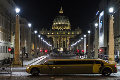 Illuminated city street at night