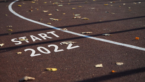 Sign start 2022 empty sports field running track markings tennis ,  grunge color. pursuit goal